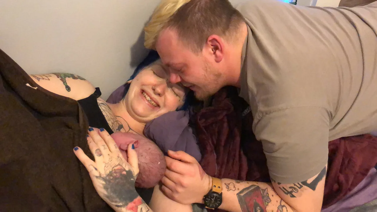 Parents greeting their newborn immediately after a home birth