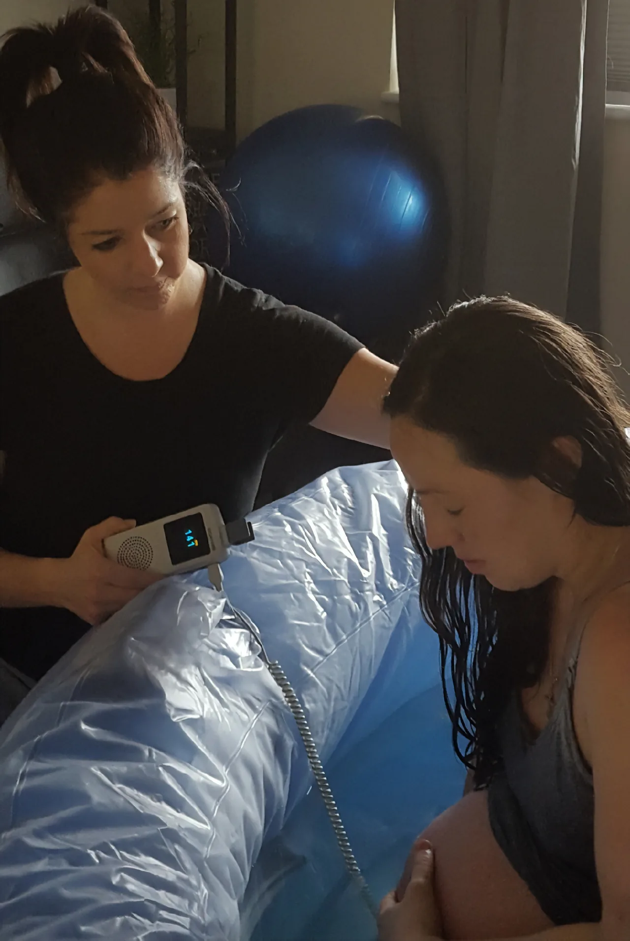 A midwife offering hands-on support to a mother during labor