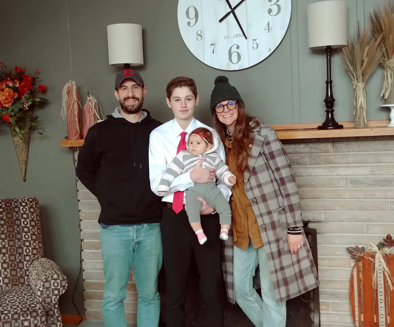 A family gathered at home with their baby after receiving midwifery care