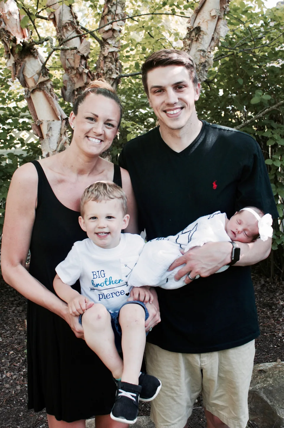 A family outdoors holding their newborn after care with Cleveland Homebirth
