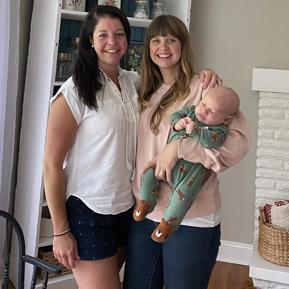 Julia Meyer with a mother and baby after a home birth
