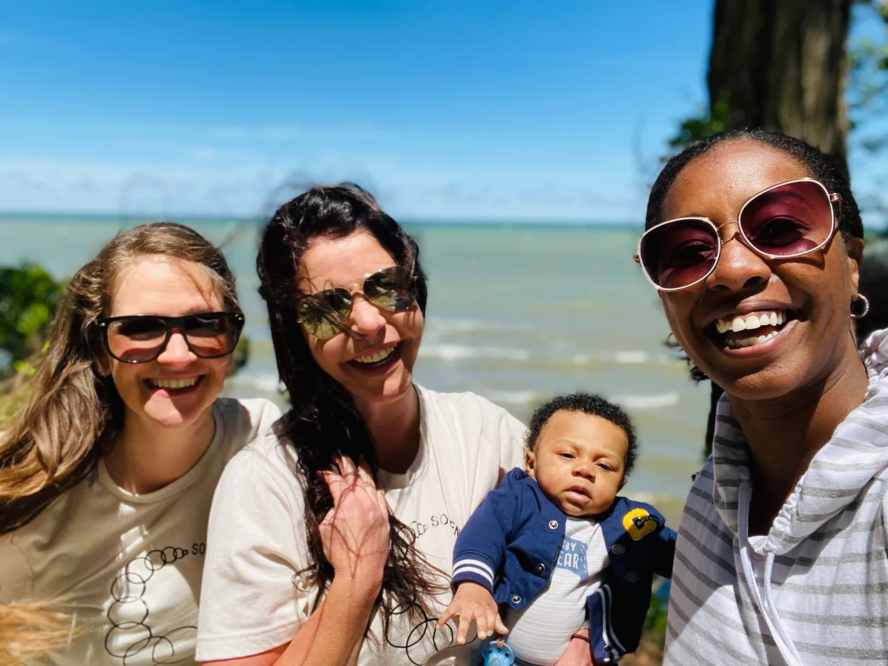 A family and members of the Cleveland Homebirth birth team smiling together